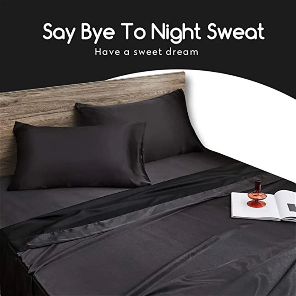 A black satin pillow cover is displayed on a bed with a dark gray duvet and a book.