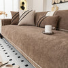 A luxurious brown chenille sofa protector cover with black stripes and a white ceramic mug on a sofa.
