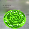 A vibrant green round area rug featuring a swirling pattern of bright green and white designs.