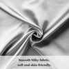 Close-up of smooth silky fabric draped in soft gray folds.