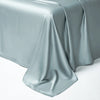 A draped sheet of silky, light blue-gray luxury Egyptian cotton bedding fabric.