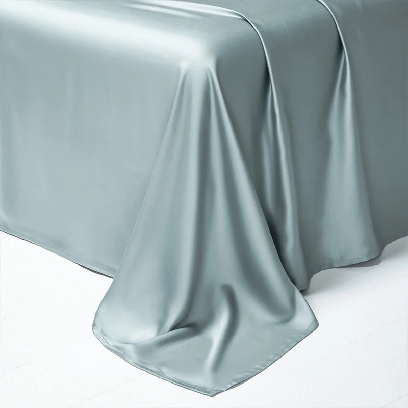 A draped sheet of silky, light blue-gray luxury Egyptian cotton bedding fabric.