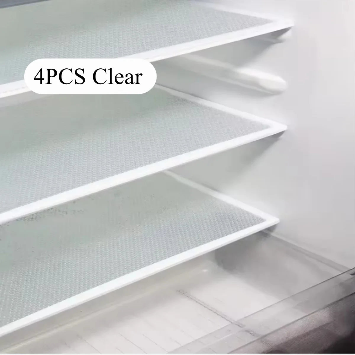 Four pieces of clear reusable silicone fridge and drawer liners displayed on a white shelf.