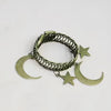 A set of two vintage metal curtain clips featuring a braided crescent moon and a star shape.