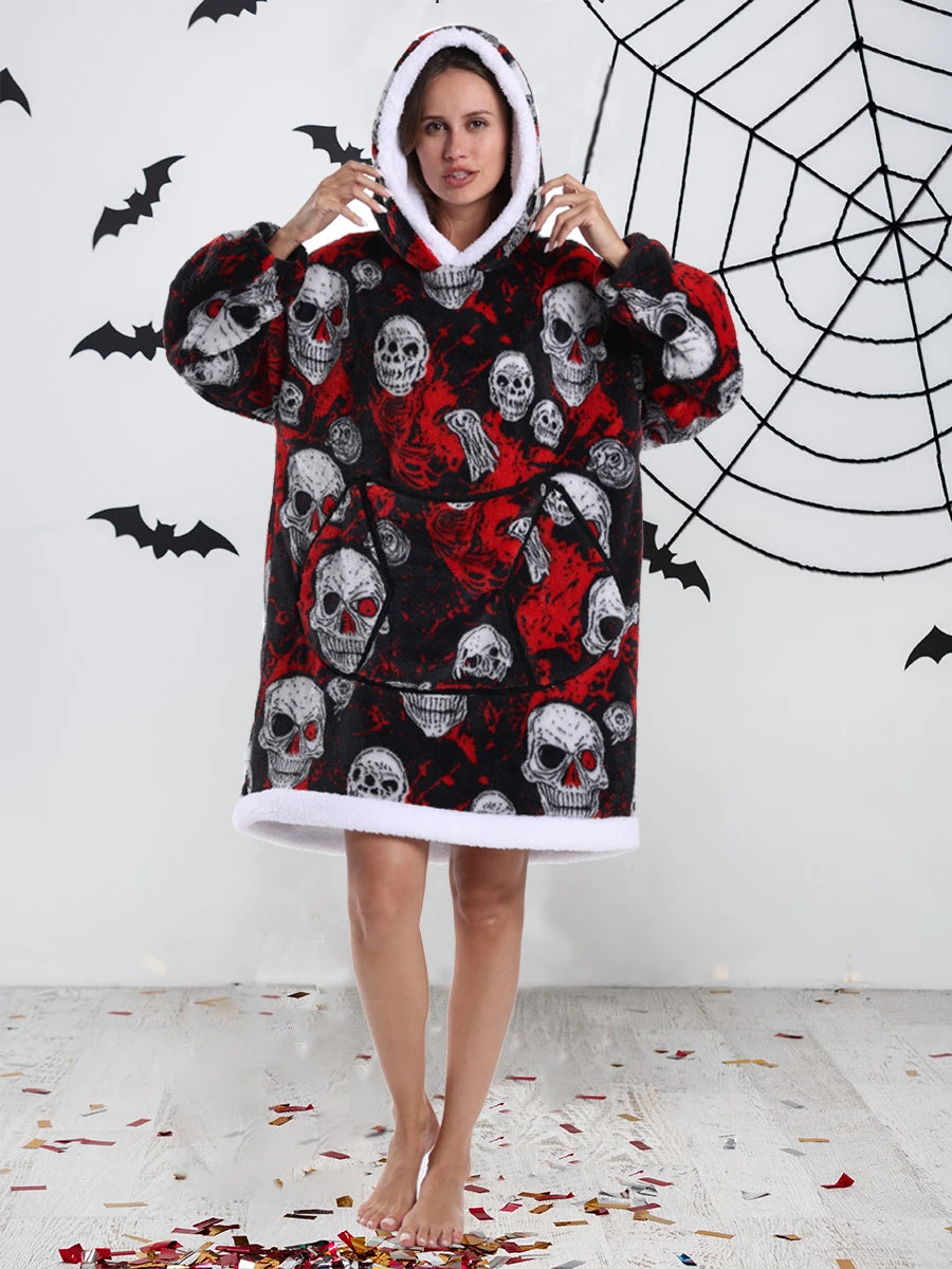 A woman wearing an oversized patchwork fleece hoodie featuring skull designs against a black background.