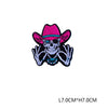 A pink sombrero embroidered patch featuring a skull design with blue accents.