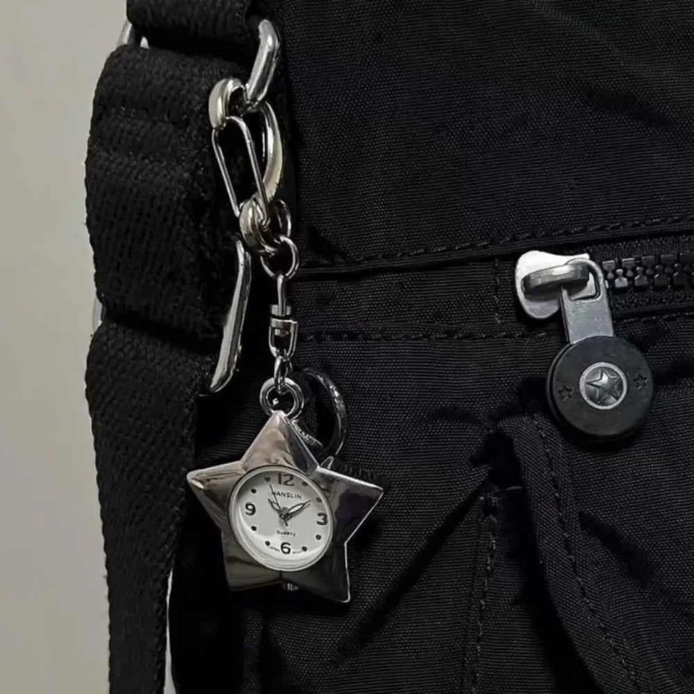Silver star-shaped pocket watch keychain attached to a black fabric strap.