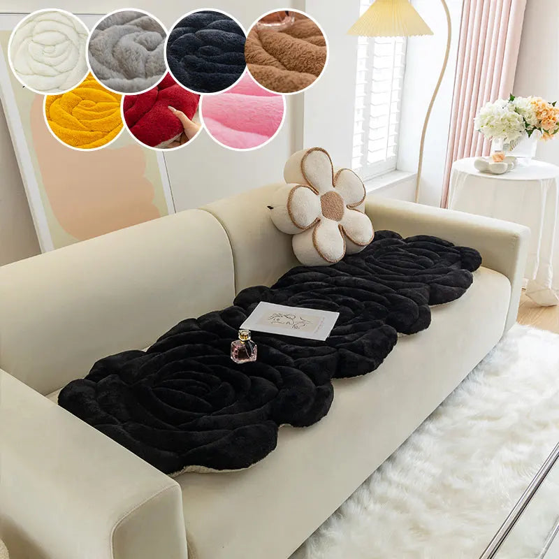 A beige sofa with a black textured mat and various colored fabric swatches displayed above.
