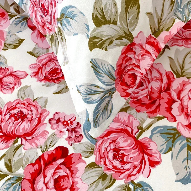 Close-up of pink and red floral print fabric used for flat bed sheets