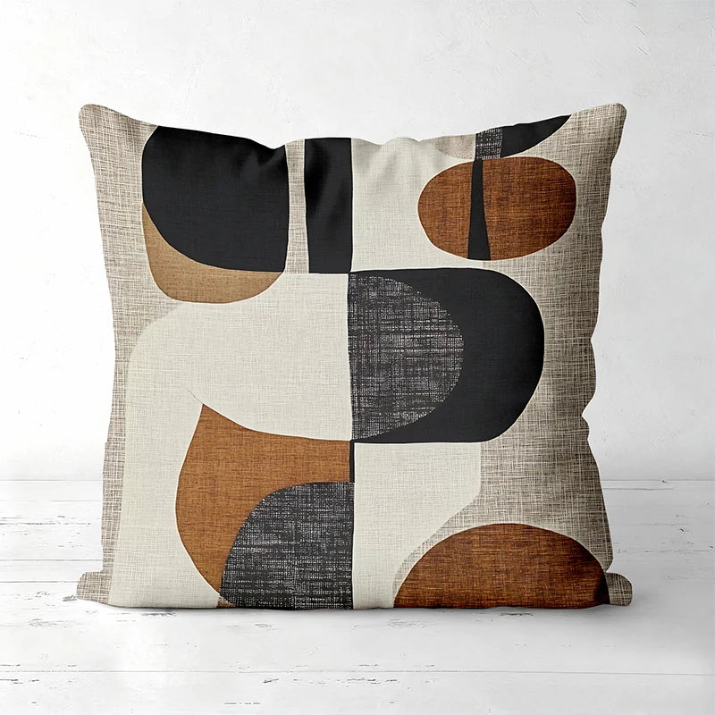 A decorative pillow cover featuring a geometric pattern in shades of black, brown, tan, and off-white.