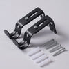 A black adjustable iron curtain rod rack with mounting brackets and screws is shown on a white background.