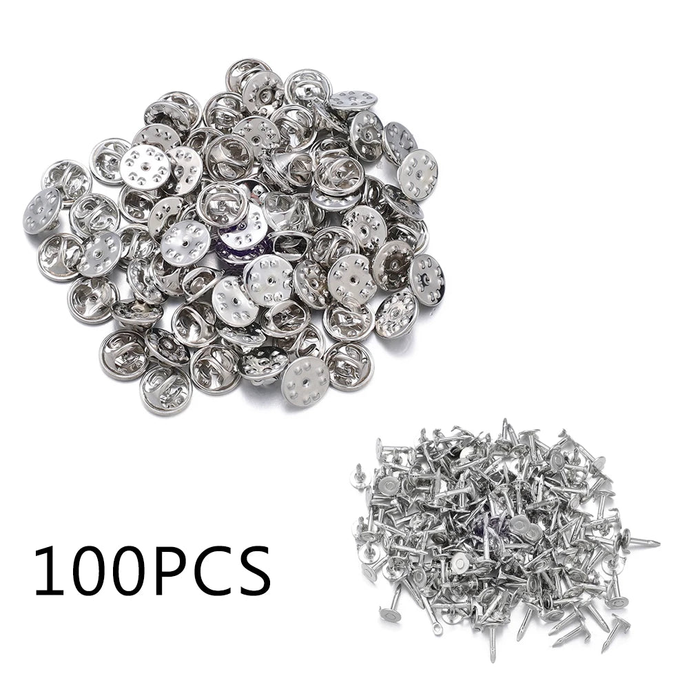 A pile of silver metal pin findings including butterfly clasps and tie tacks for jewelry making