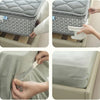 Hands are shown using invisible bed sheet fixing clips to secure a mattress cover onto a bed frame.
