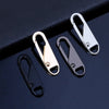 A set of four detachable metal zipper puller repair kits in gold and silver finishes displayed on a dark surface.