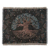 A dark throw blanket featuring a stylized tree and roots design in muted teal and brown tones.