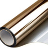 A close-up view of a bronze one way mirror window film rolled up, showing its reflective surface.