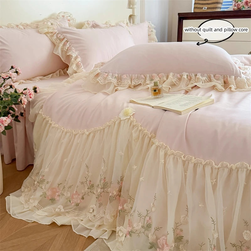 A pink and cream Korean style lace embroidered duvet set displayed on a bed with sheer fabric layers.