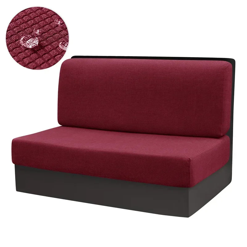 A deep red water repellent stretch sofa and chair cover with a textured fabric detail.