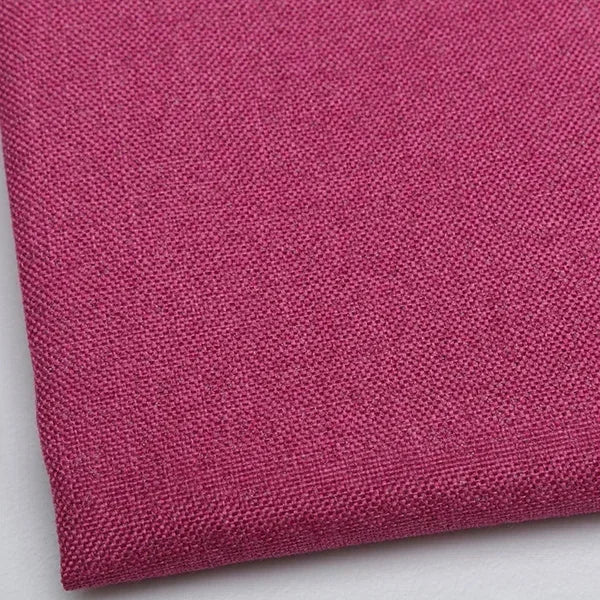 Close-up of a deep magenta coarse linen and cotton fabric texture.