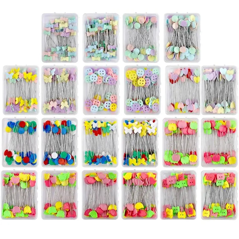 A grid of nickel-plated dressmaking pins with colorful heads in various shades and styles.