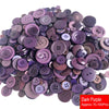 A pile of assorted dark purple resin sewing buttons for crafting and DIY projects.