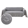 A gray waterproof sofa cover draped over a piece of furniture.