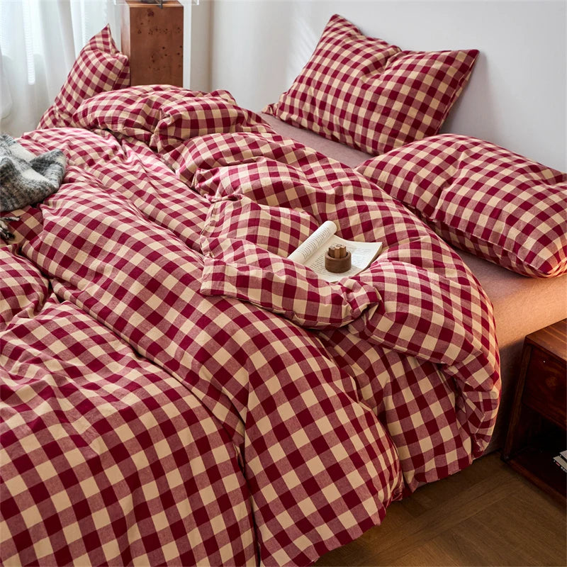 A set of hand-dyed cotton plaid duvet covers in maroon and beige tones with a checkered pattern.