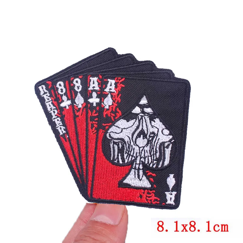 A black embroidery patch featuring a rose skull design with red accents.