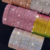 A collection of colorful diamond rhinestone strips for DIY decor displayed against a dark background.