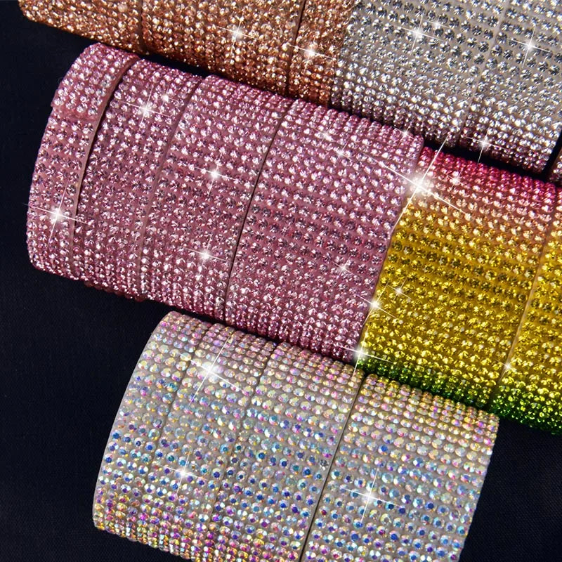 A collection of colorful diamond rhinestone strips for DIY decor displayed against a dark background.