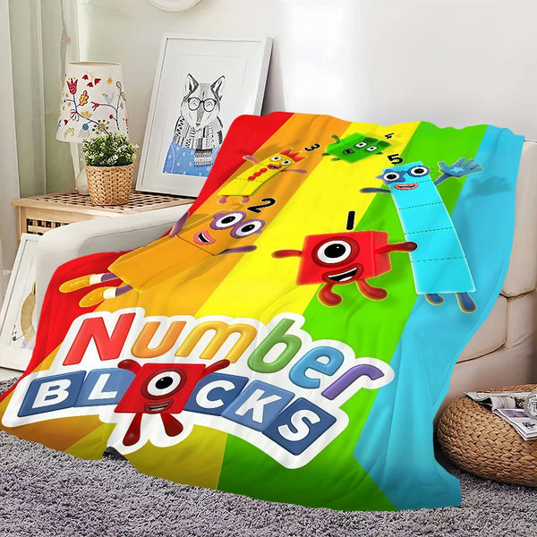A colorful throw blanket featuring cartoon animals and the text Number Blocks.