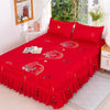 A vibrant red fitted bed sheet set with elastic lace trim displayed on a bed.