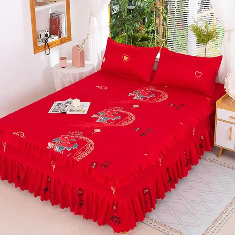 A vibrant red fitted bed sheet set with elastic lace trim displayed on a bed.