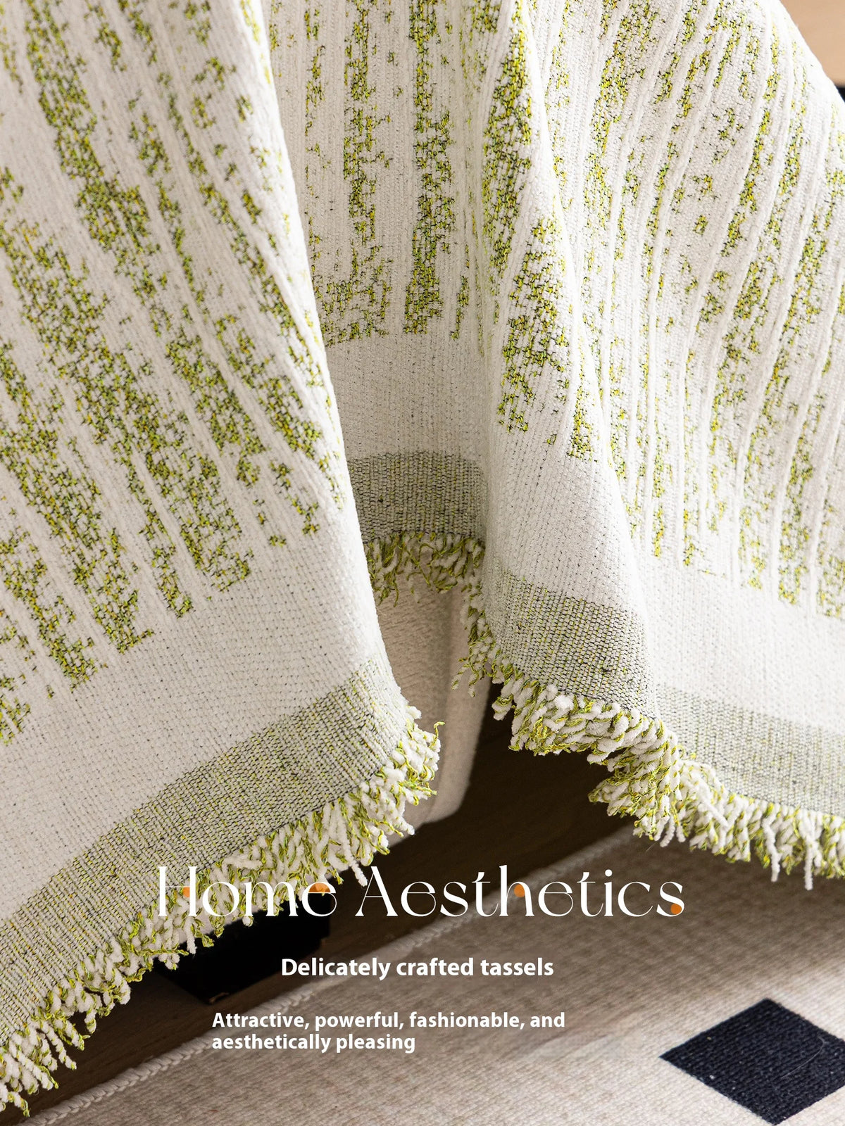 A close-up of an elegant cream and lime green textured fabric blanket with fringed edges.