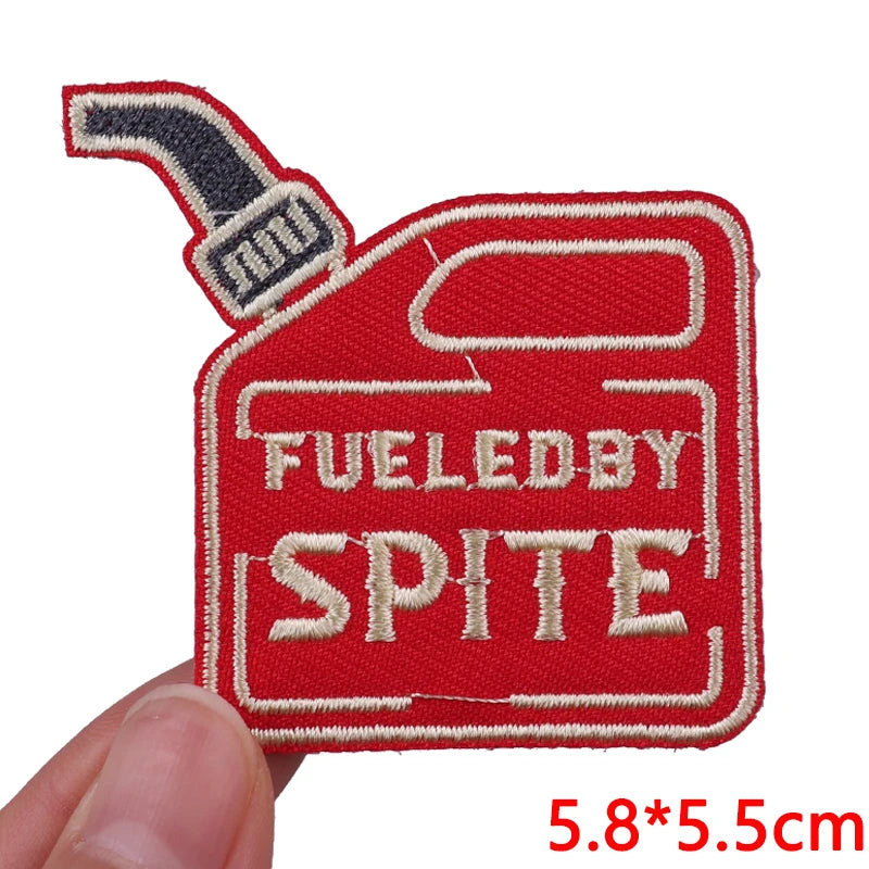 Red embroidered patch featuring the text FUELED BY SPITE on a heart-shaped design