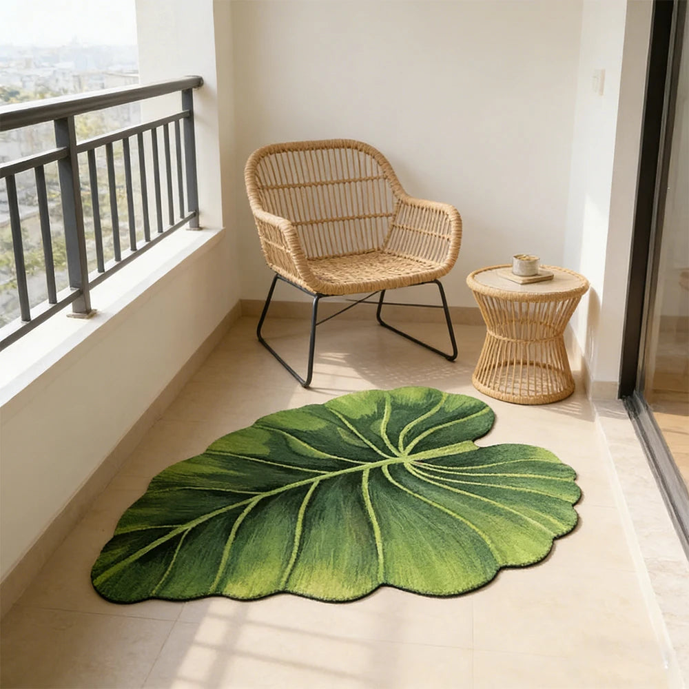 A large green leaf-shaped quick-dry bathroom mat with a rubber backing placed on a light floor.