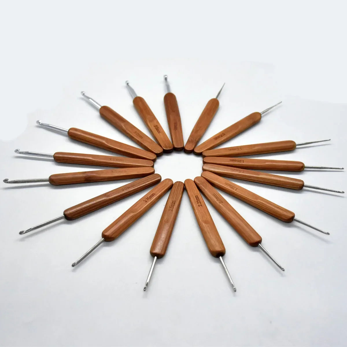 A set of bamboo crochet knitting needles arranged in a circular pattern on a white background.