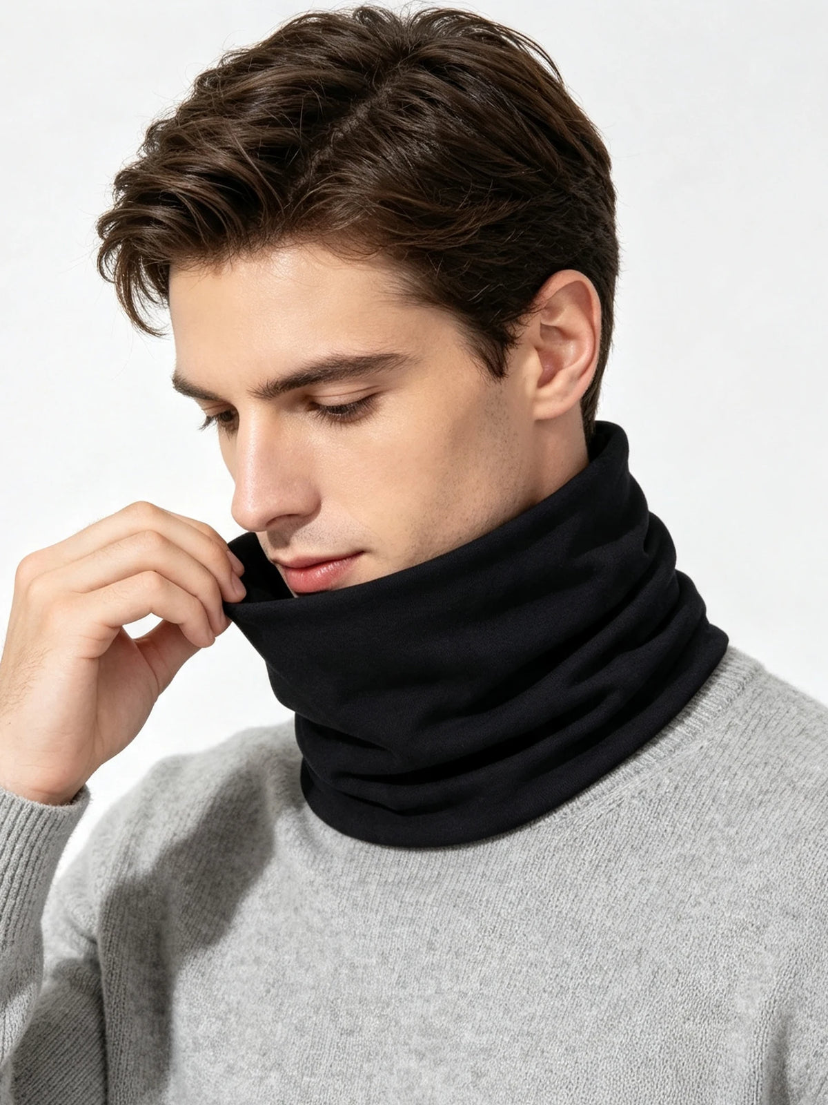 A man wearing a black soft cotton warm neck scarf around his neck, visible against a light gray sweater.