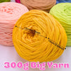 A ball of bright yellow 300g big yarn is shown next to other colored yarns.