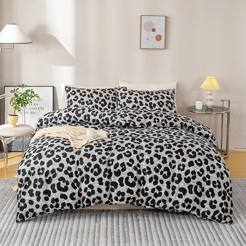 A luxury leopard print duvet cover set displayed on a bed with modern lighting and wall art.