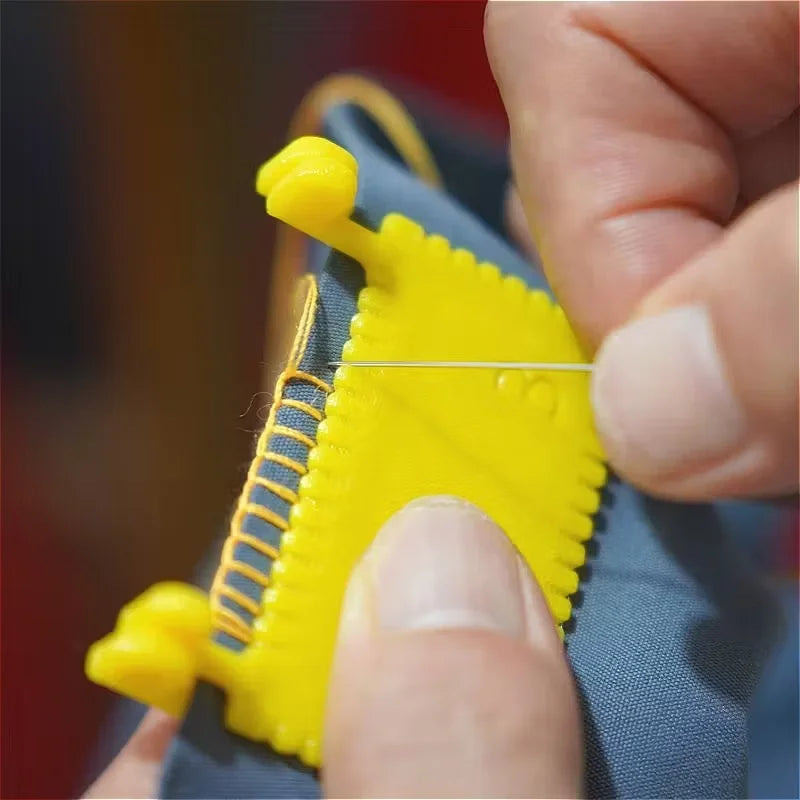 A hand is using a hinge-type fabric sewing guide with a measuring scale to mark fabric.