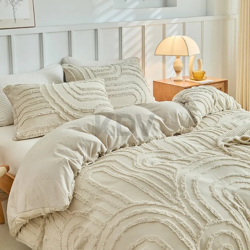 A beige embossed floral duvet cover set with matching pillowcases displayed on a bed.