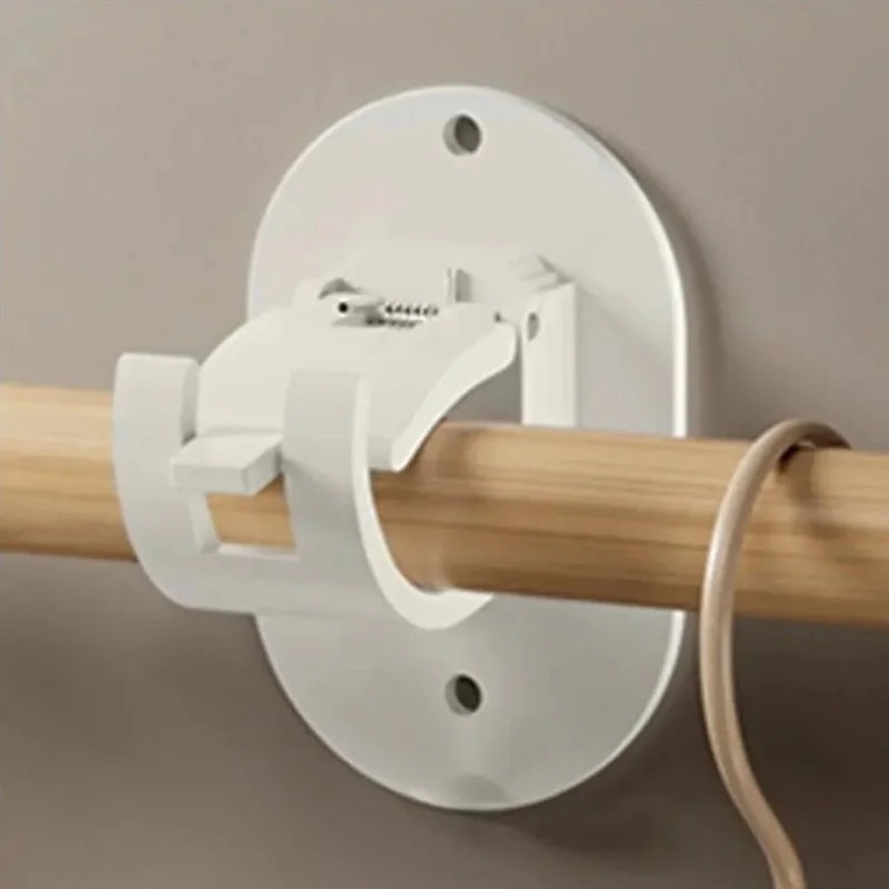 A white heavy duty self-adhesive curtain rod holder is mounted on a wall, designed to secure a wooden curtain rod.