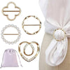 Gold round heart button clips for clothing and accessories displayed on a white fabric background