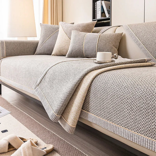 A light beige woven sofa cushion cover with gray accents and pillows on a modern bed.