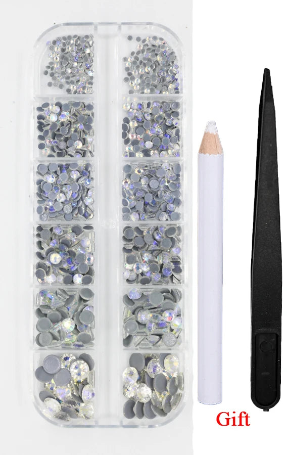 A clear plastic container holds various sizes of silver and iridescent rhinestones with an applicator tool.