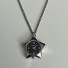 Silver chain necklace with a star-shaped pocket watch pendant displaying the time.