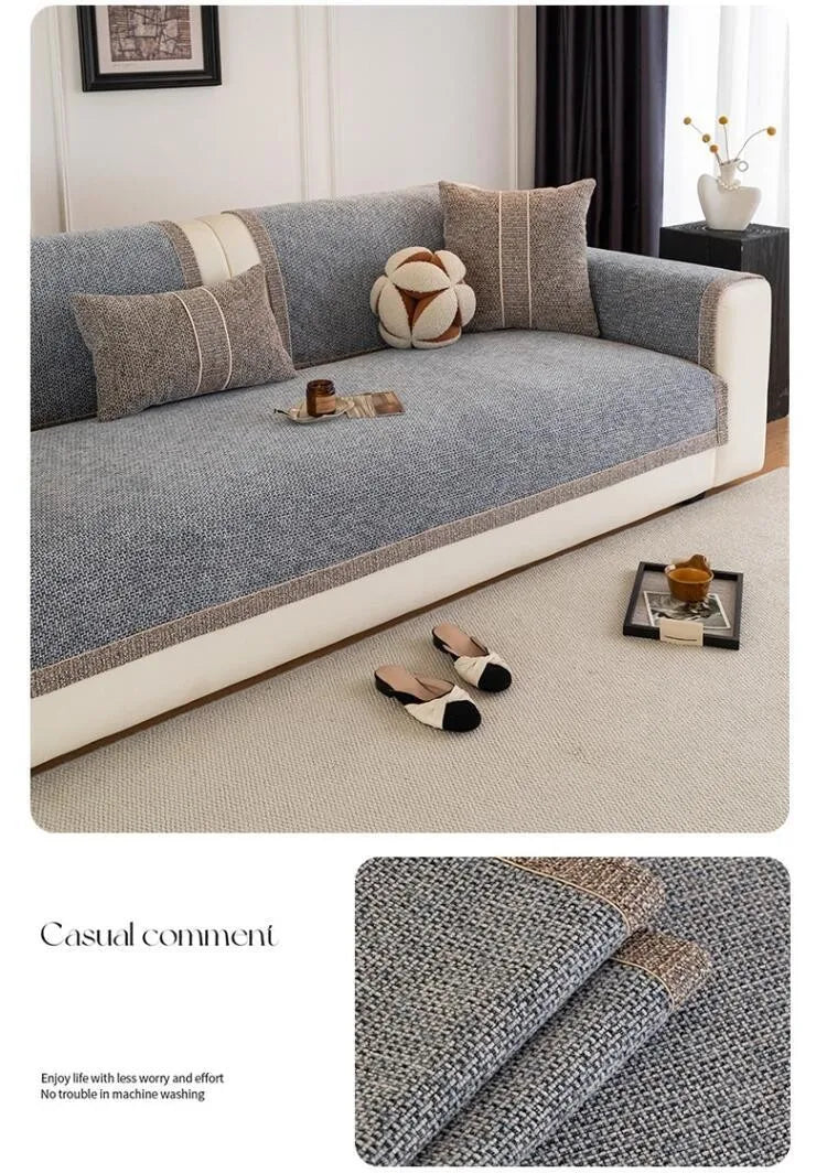 A gray sofa cushion cover with beige accents and a textured fabric displayed on a light carpet.