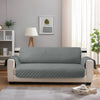 A light gray waterproof anti-slip sofa slipcover displayed on a modern white sofa in a bright living room.