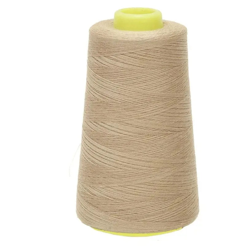 A roll of beige sewing thread with a yellow core and plastic spool visible.